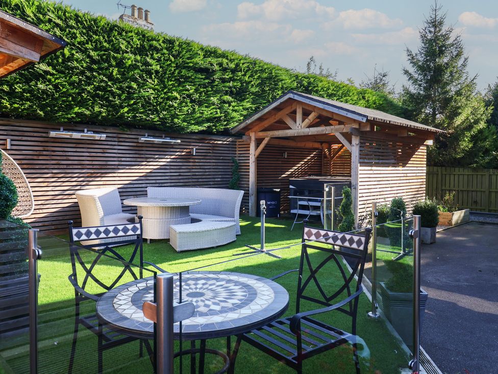 A garden with seating and a gazebo at Ten Gables in Driffield