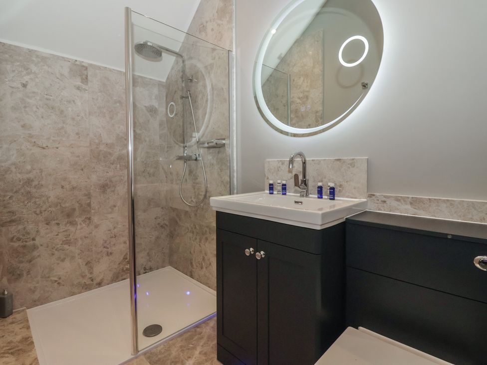 A bathroom with a shower and sink at Ten Gables in Driffield