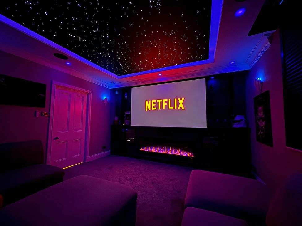 A home theater with a screen displaying Netflix at Ten Gables in Driffield