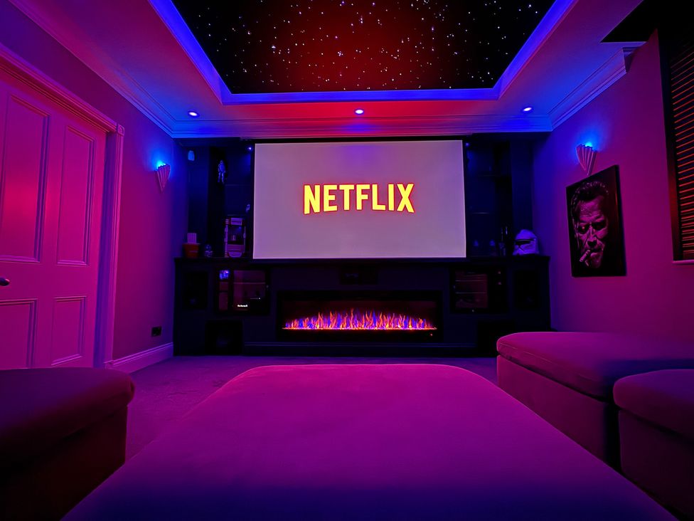 A home theater with a Netflix screen and decorative lighting at Ten Gables in Driffield