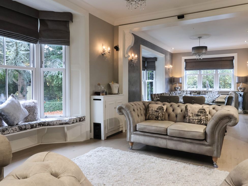 A living room with a sofa and dining area at Ten Gables in Driffield