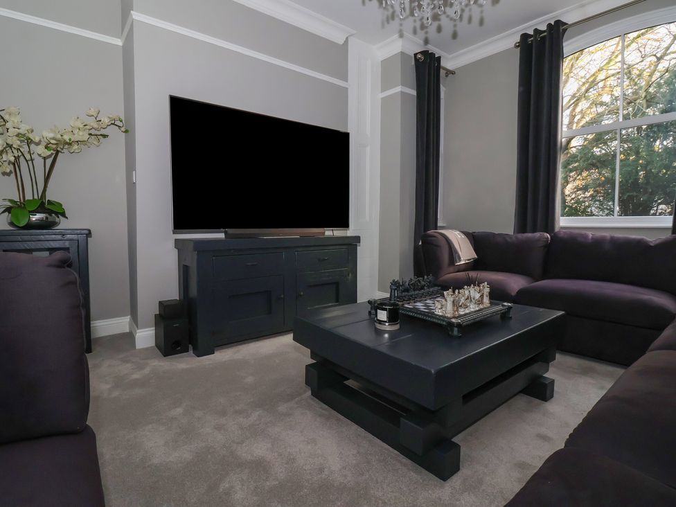 A living room with a coffee table and television at Ten Gables in Driffield