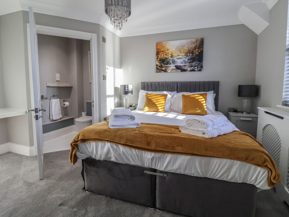 A bedroom with a bed and bathroom view at Ten Gables in Driffield