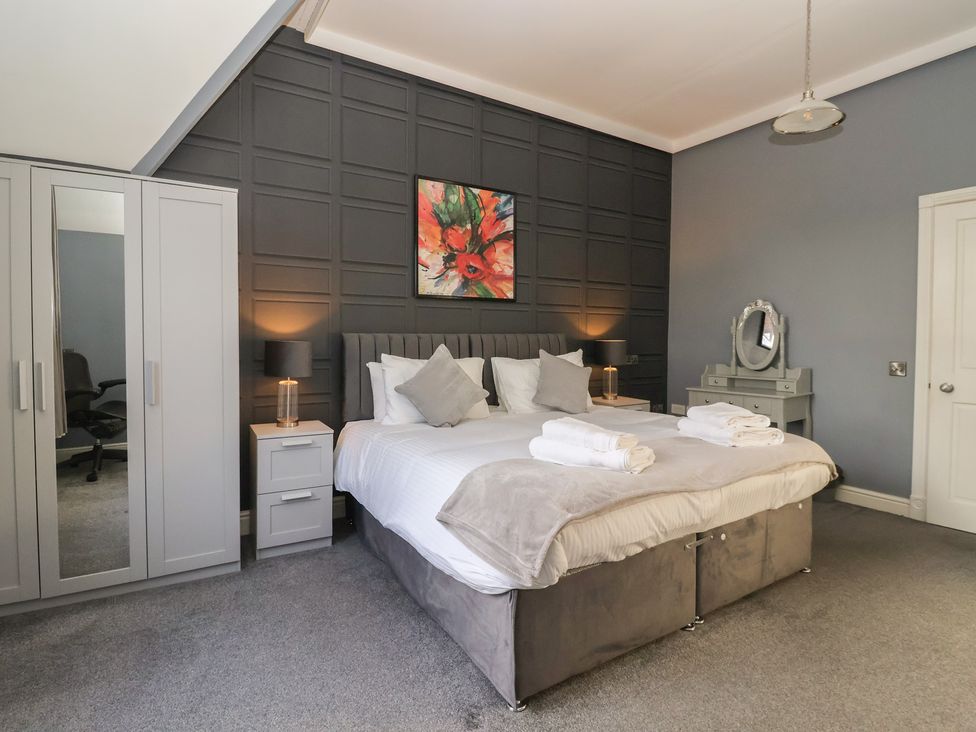 A bedroom with a bed and furniture at Ten Gables in Driffield
