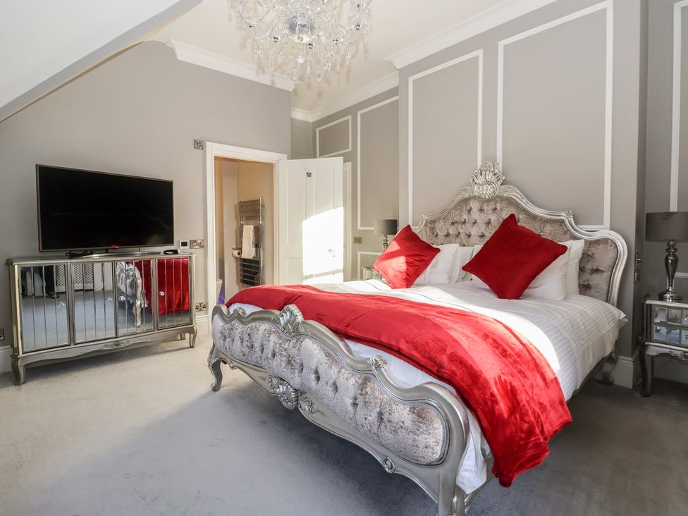 A bedroom with a bed and television at Ten Gables in Driffield