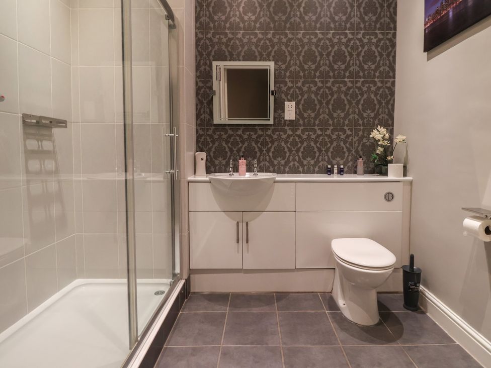 A bathroom with a shower and sink at Ten Gables in Driffield