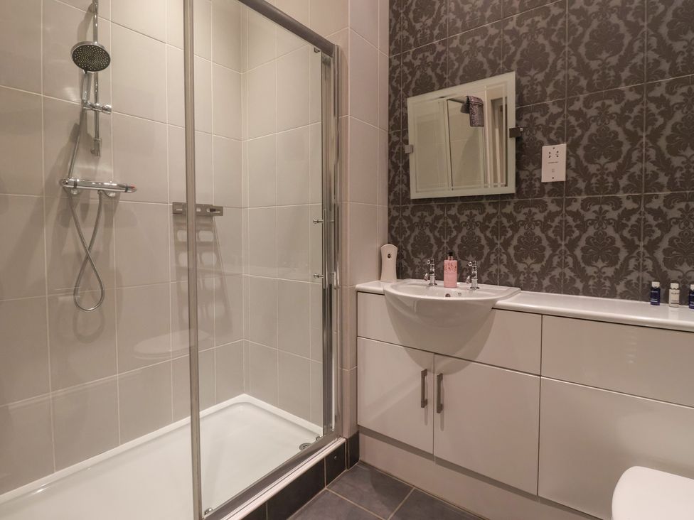 A bathroom with a shower and sink at Ten Gables in Driffield