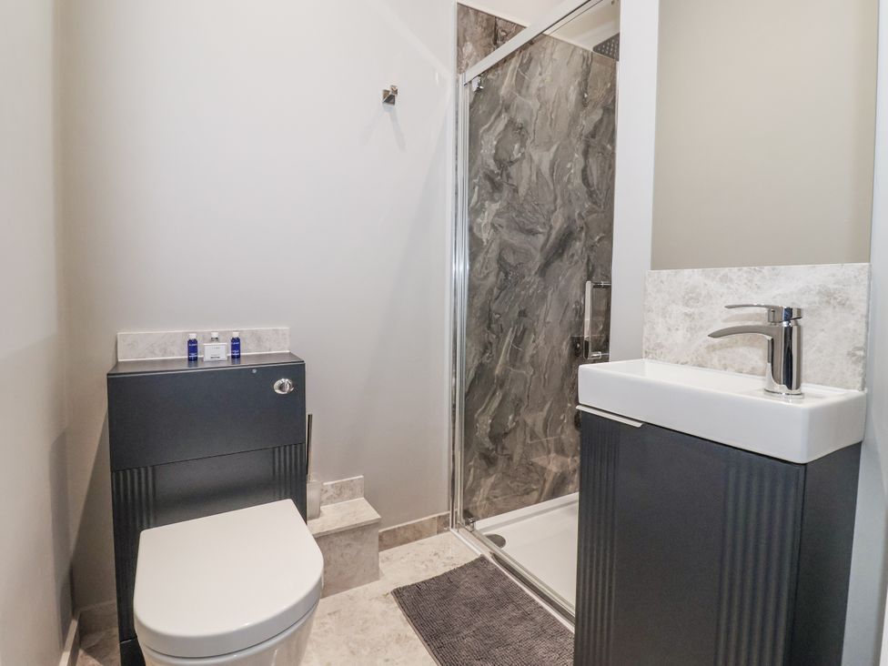 A bathroom with a shower and sink at Ten Gables in Driffield