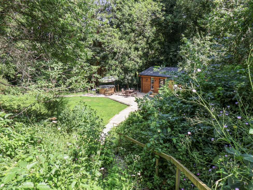 A garden with a cabin and seating area at Roe Deer Lodge in Littlebeck near Sleights