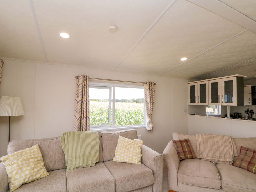 A living room with sofas and a window at The Cosy Caravan near Thirsk