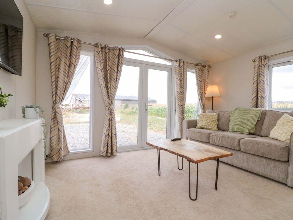A living room with a sofa and coffee table at The Cosy Caravan in Islebeck near Thirsk