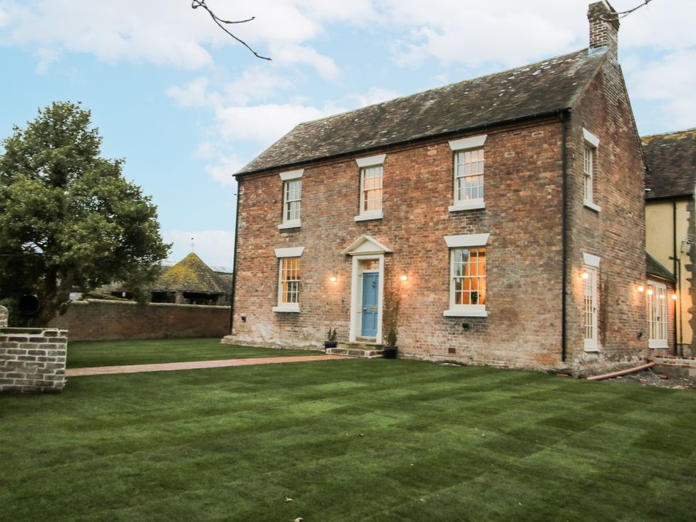 A house with a brick exterior and lawn at Highfields Farm in Church Preen near Much Wenlock
