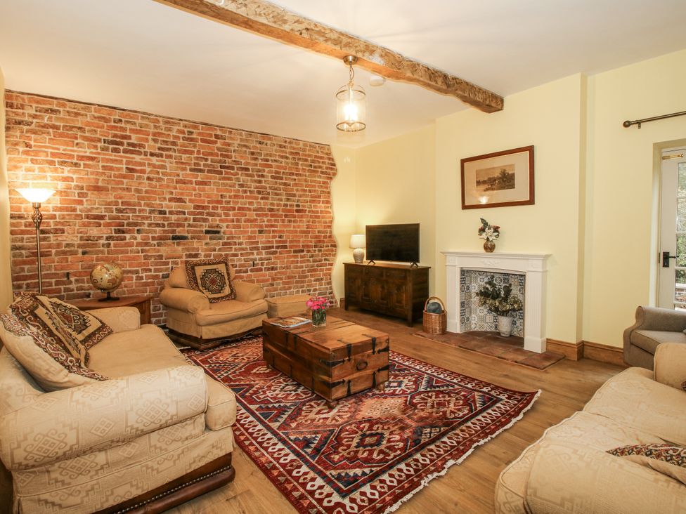 A living room with a coffee table and television at Highfields Farm Church Preen near Much Wenlock