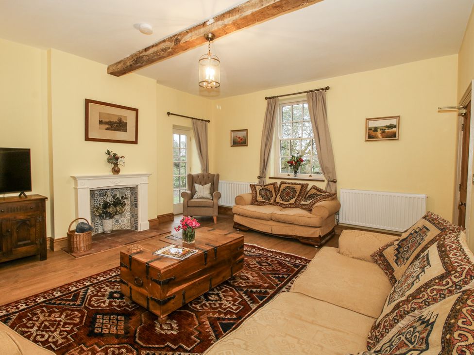 A living room with a sofa and armchair at Highfields Farm Church Preen near Much Wenlock