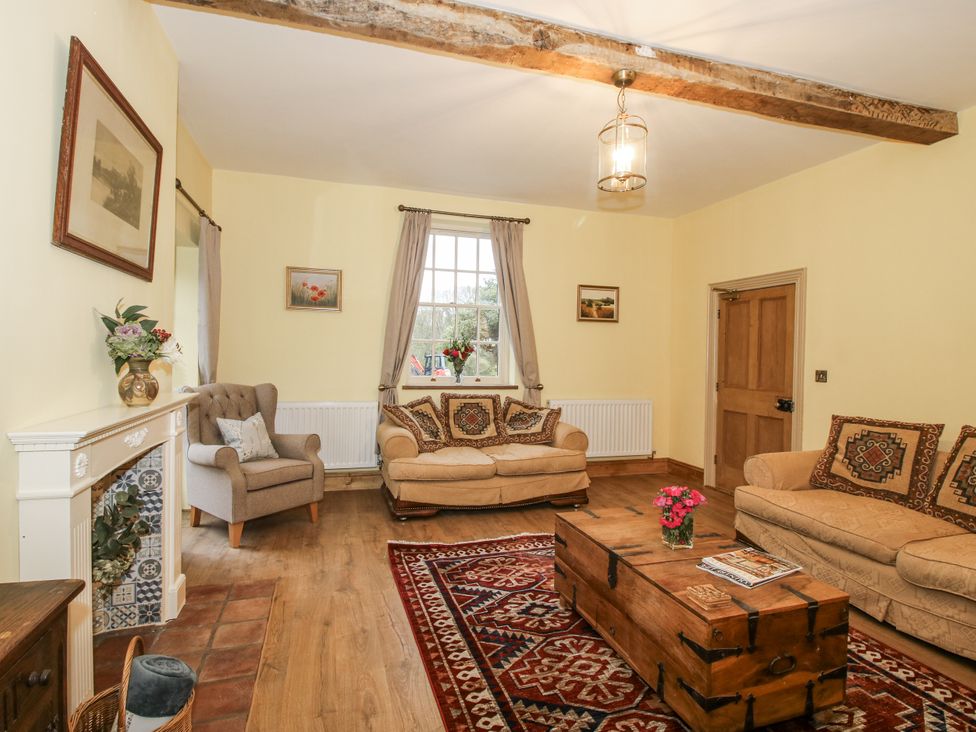 A living room with sofas and a coffee table at Highfields Farm in Church Preen near Much Wenlock