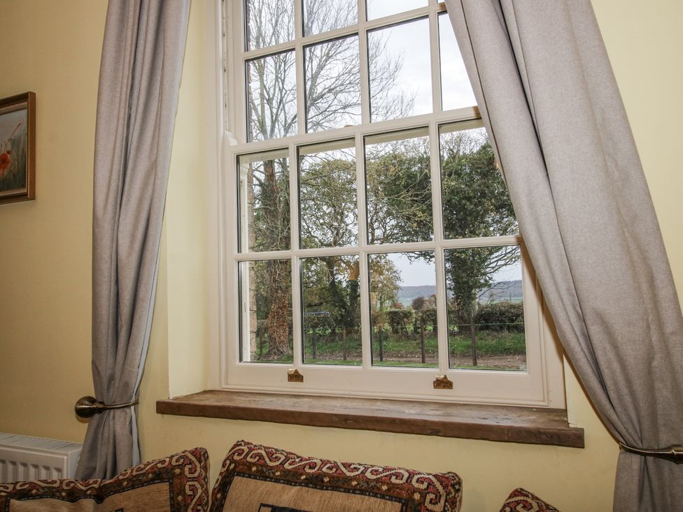 A window with curtains and artwork at Highfields Farm Church Preen near Much Wenlock