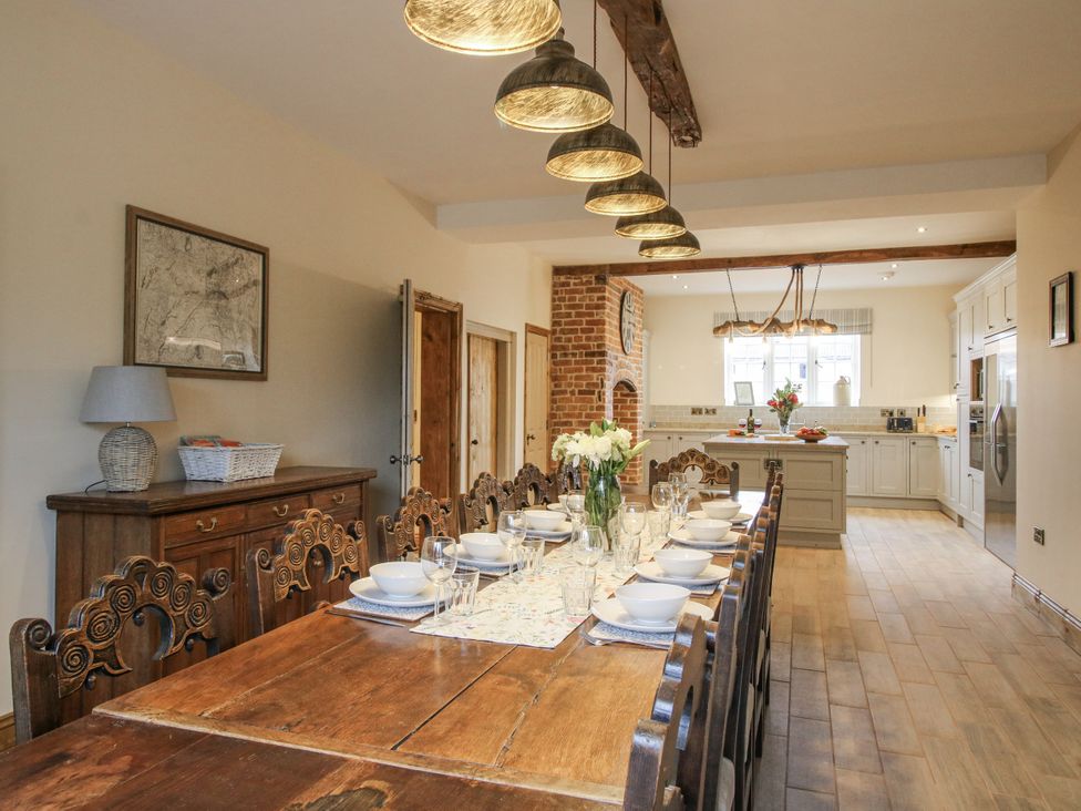 A kitchen with a dining table and chairs at Highfields Farm in Church Preen near Much Wenlock