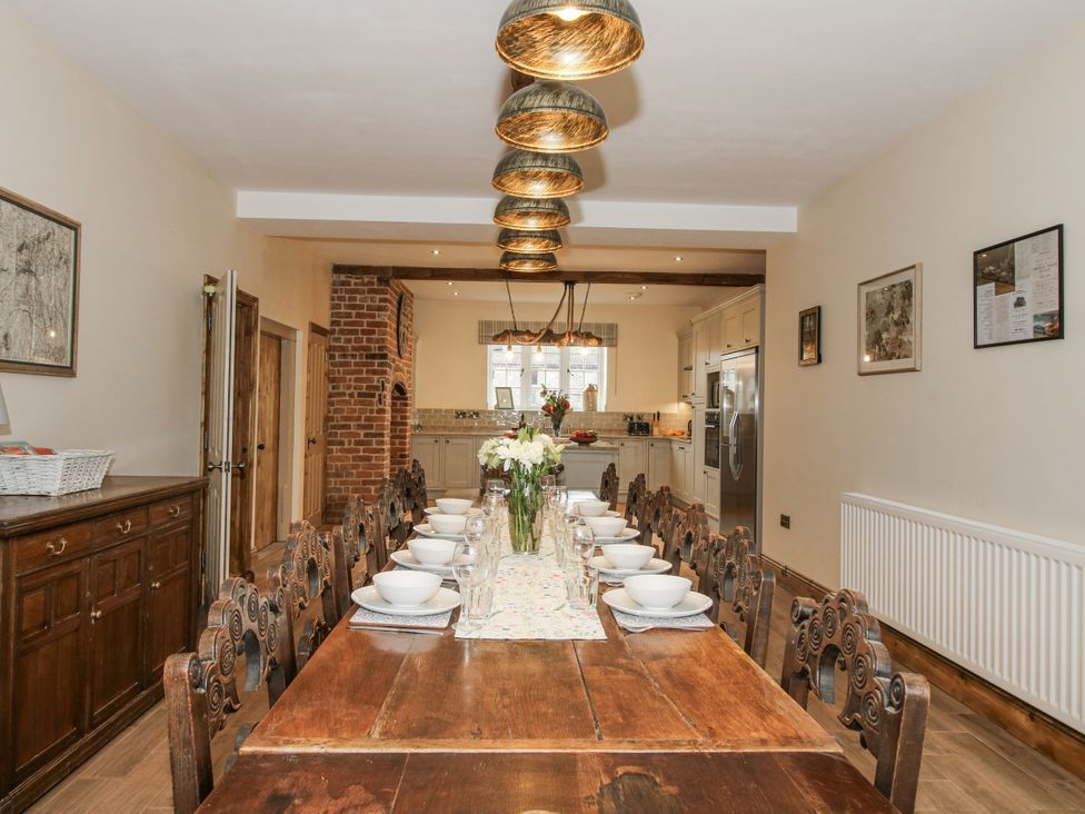 A dining room with a long table set for a meal at Highfields Farm Church Preen near Much Wenlock