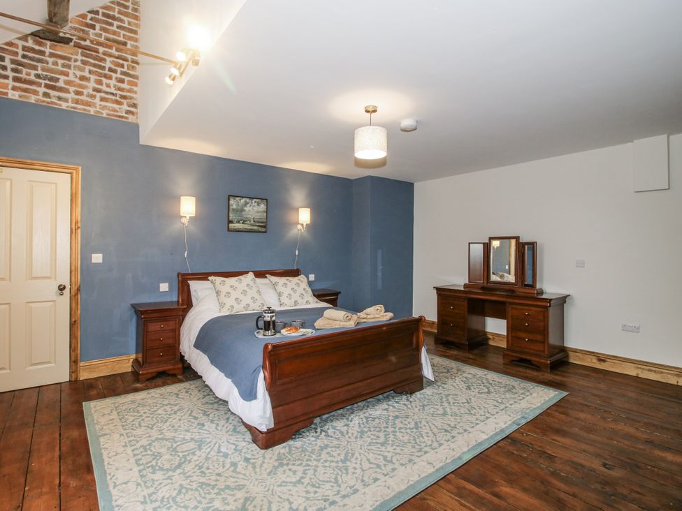 A bedroom with a bed and dressing table at Highfields Farm Church Preen near Much Wenlock