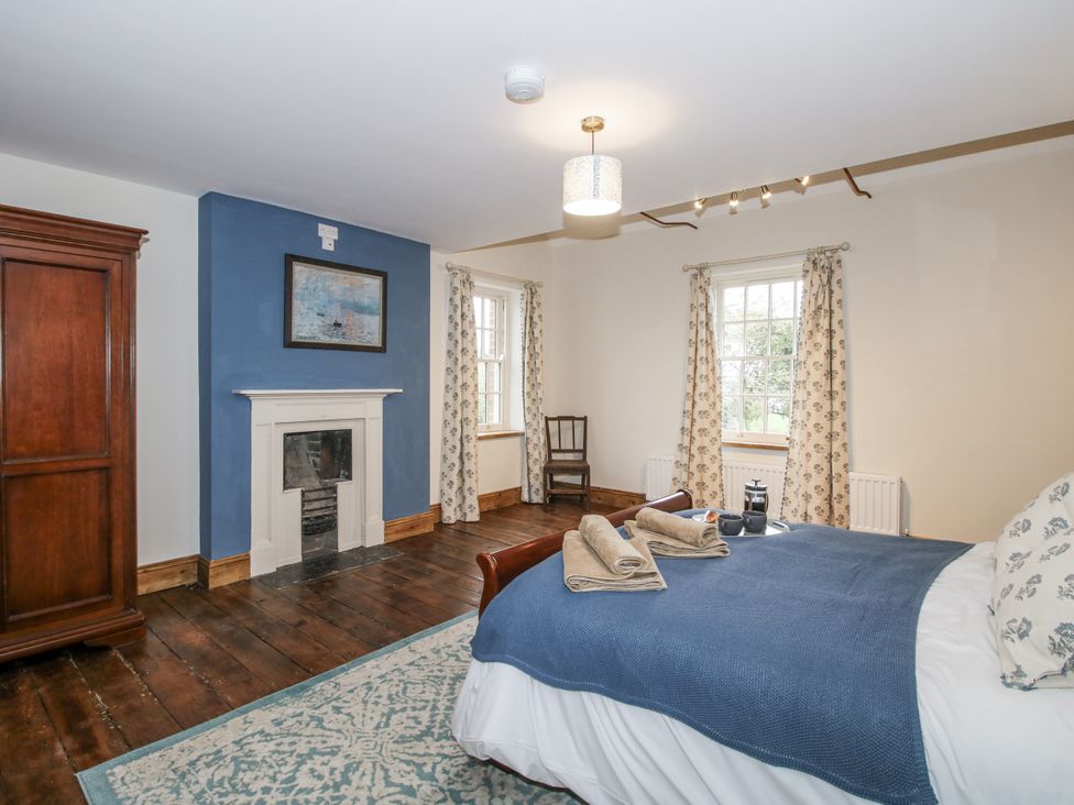 A bedroom with a bed and wardrobe at Highfields Farm in Church Preen near Much Wenlock