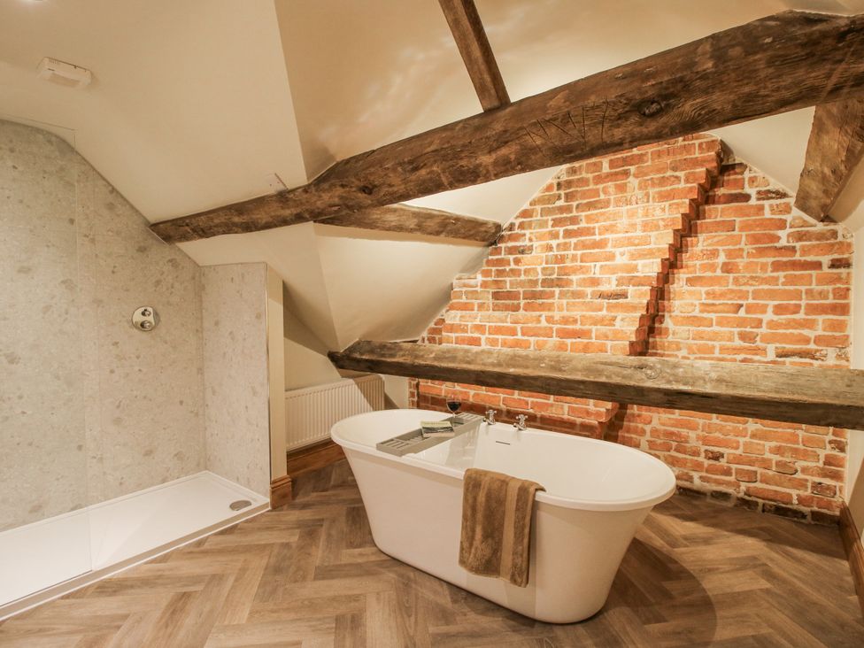 A bathroom with a freestanding bathtub and shower at Highfields Farm Church Preen near Much Wenlock