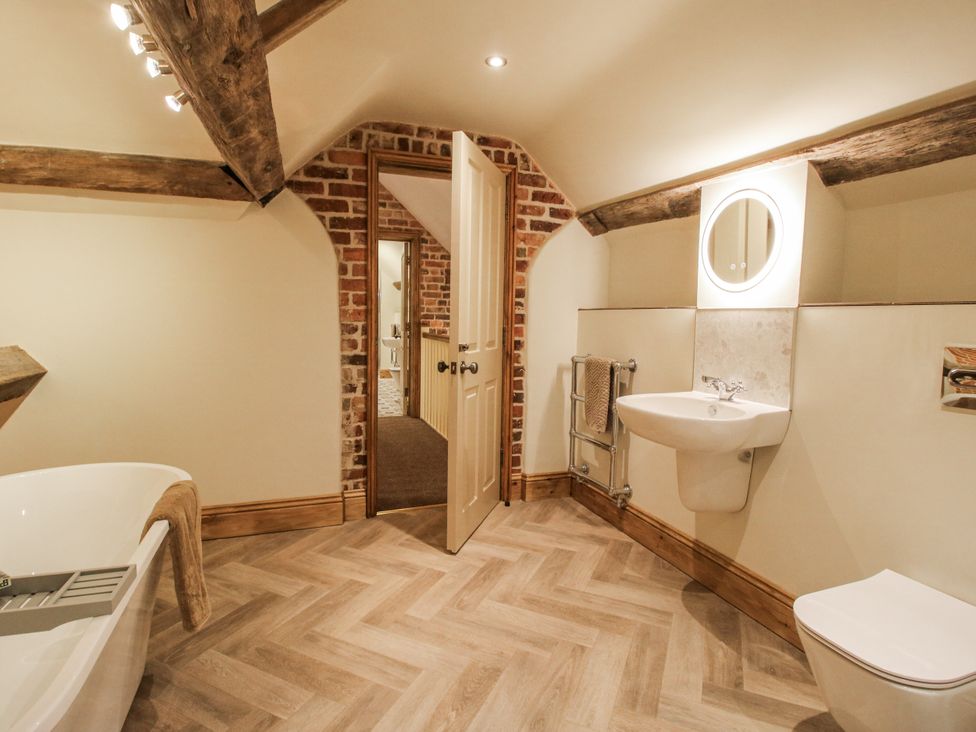 A bathroom with a bathtub and a sink at Highfields Farm Church Preen near Much Wenlock