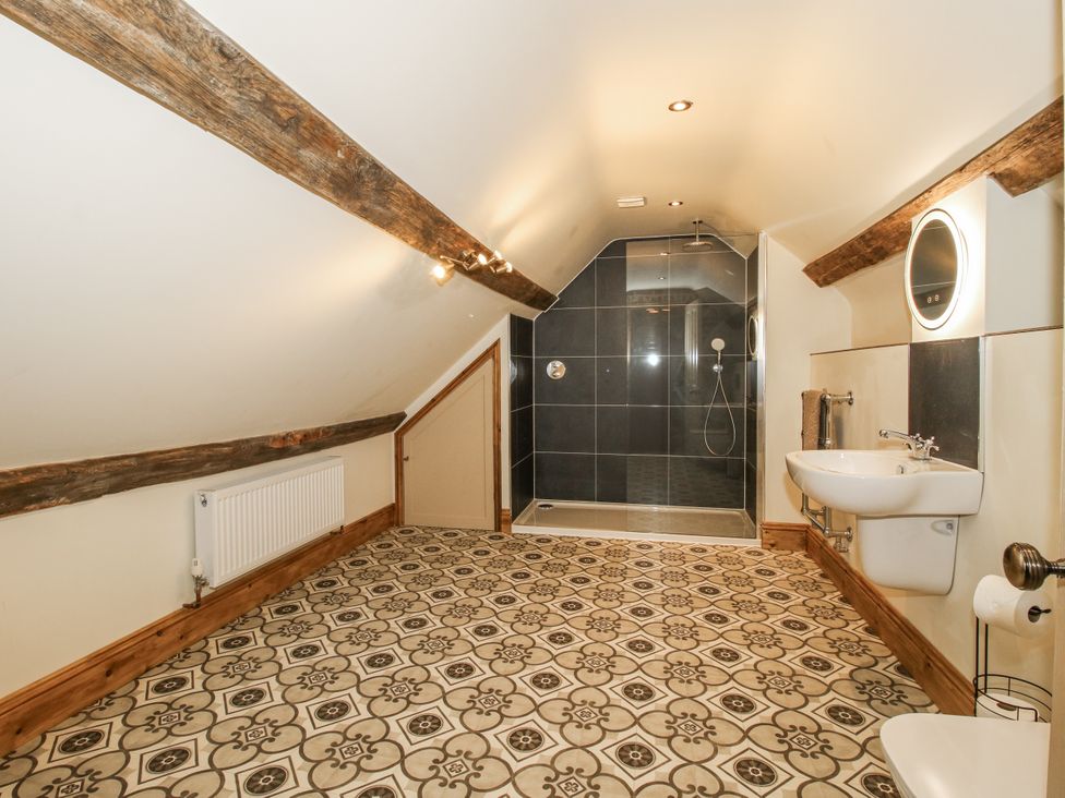 A bathroom with a shower, sink, and toilet at Highfields Farm in Church Preen near Much Wenlock
