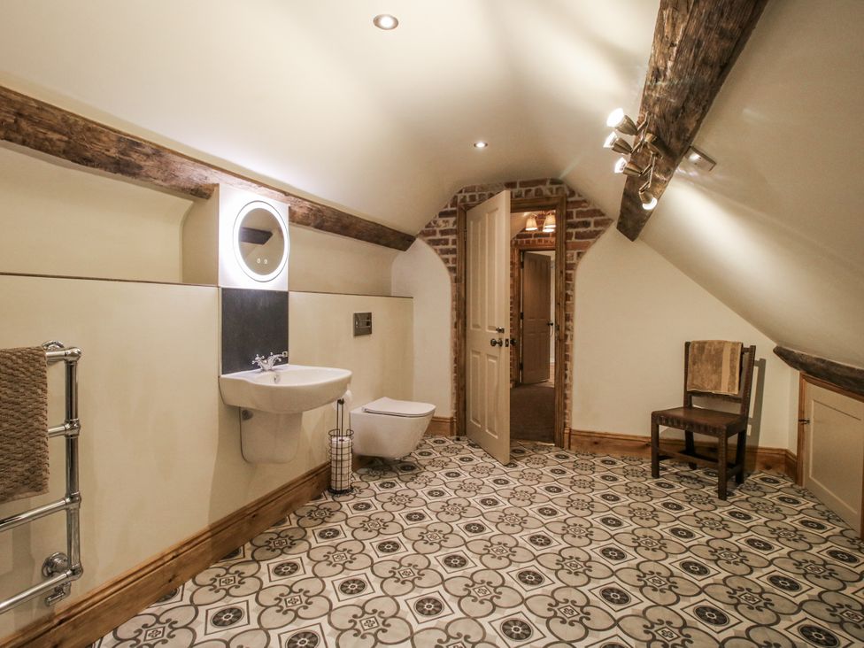 A bathroom with a sink, toilet, and towel rail at Highfields Farm Church Preen near Much Wenlock