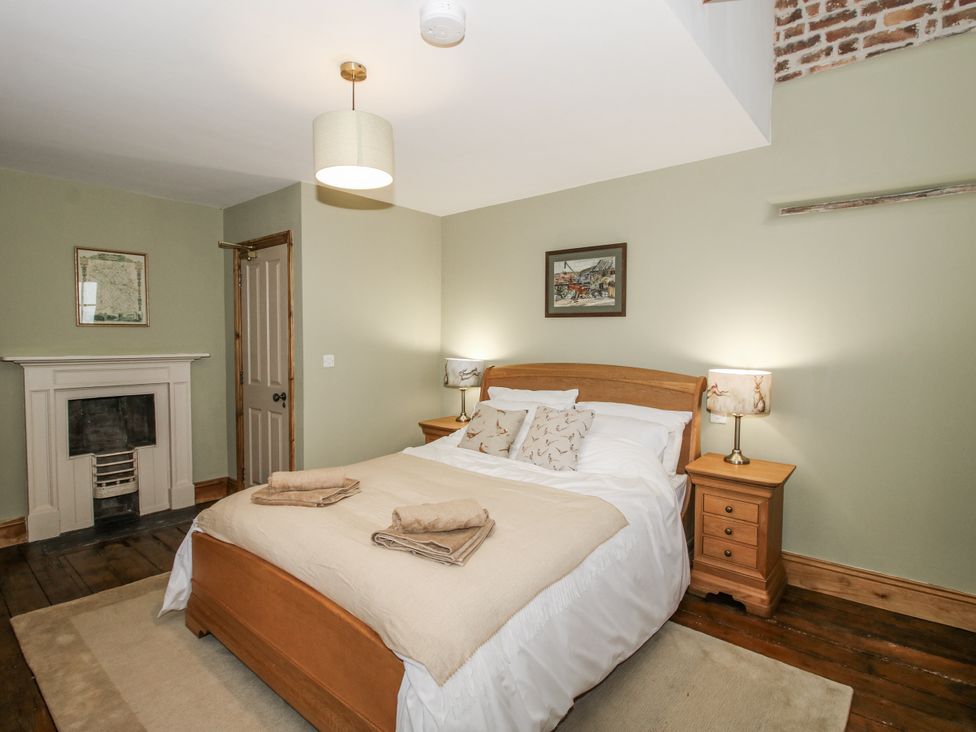 A bedroom with a bed and lamps at Highfields Farm in Church Preen near Much Wenlock