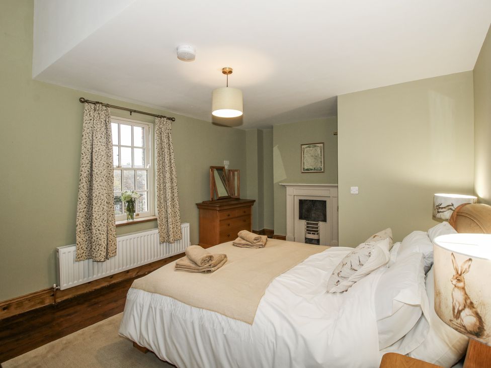 A bedroom with a bed, dresser, and window at Highfields Farm Church Preen near Much Wenlock