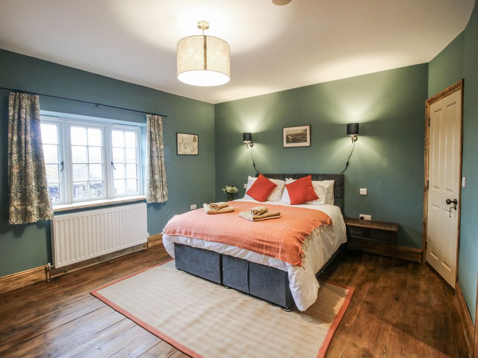 A bedroom with a bed and window at Highfields Farm Church Preen near Much Wenlock