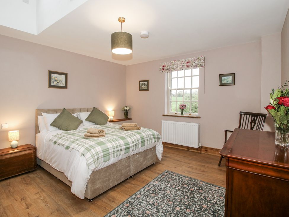 A bedroom with a bed, lamp, and desk at Highfields Farm Church Preen near Much Wenlock