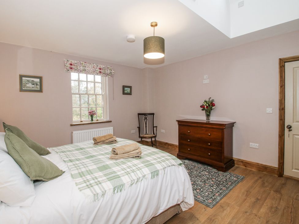 A bedroom with a bed, dresser and window at Highfields Farm Church Preen near Much Wenlock