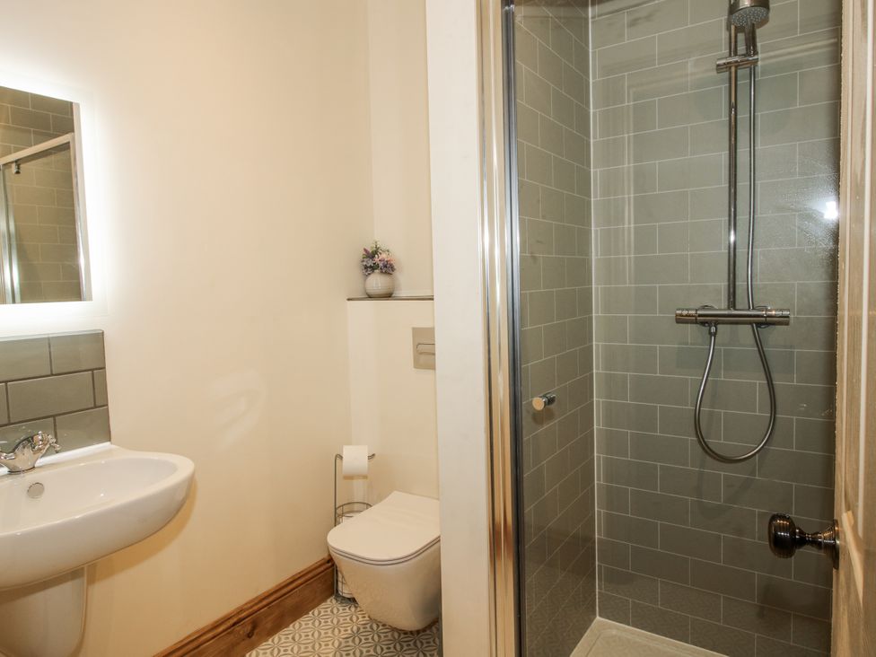A bathroom with a sink, toilet, and shower at Highfields Farm Church Preen near Much Wenlock