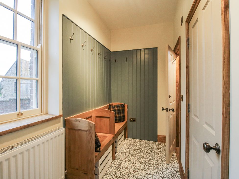 An entrance hallway with a bench and coat hooks at Highfields Farm in Church Preen near Much Wenlock
