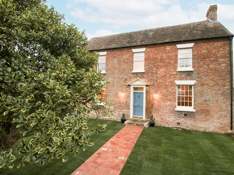 A house with a blue door and garden at Highfields Farm in Church Preen near Much Wenlock