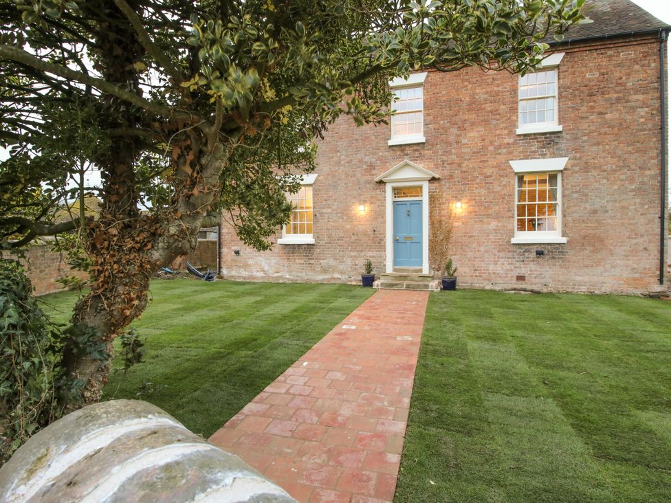 A house with a blue door and pathway at Highfields Farm Church Preen near Much Wenlock