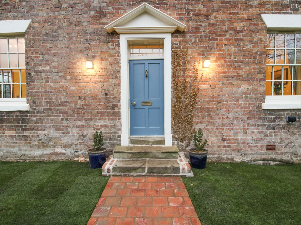 An exterior view showing a blue door and pathway at Highfields Farm in Church Preen near Much Wenlock