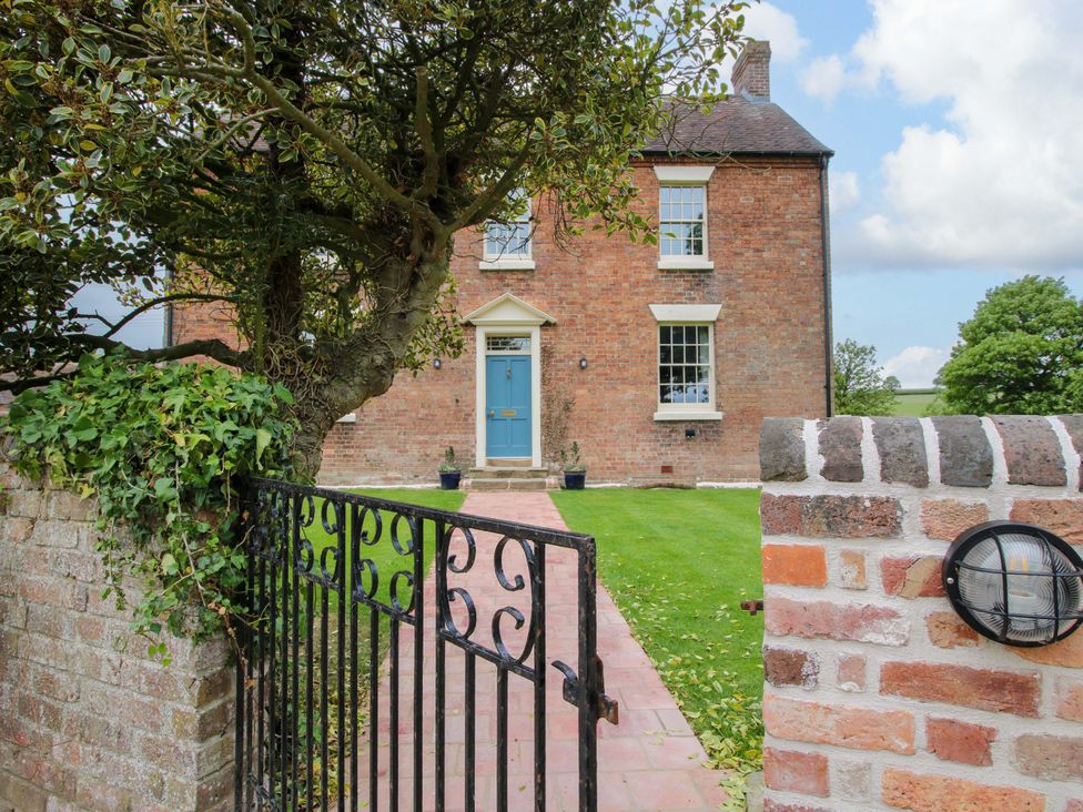 A house with a blue door and garden at Highfields Farm Church Preen near Much Wenlock