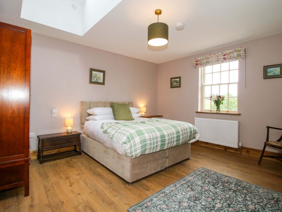 A bedroom with a bed and nightstand at Highfields Farm Church Preen near Much Wenlock