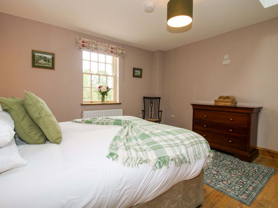 A bedroom with a bed and chair at Highfields Farm in Church Preen near Much Wenlock