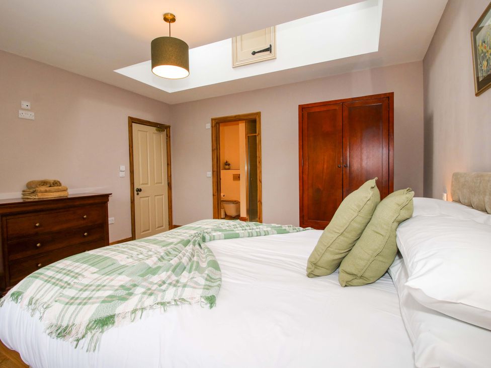 A bedroom with a bed and wardrobe at Highfields Farm in Church Preen near Much Wenlock