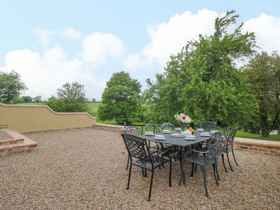 An outdoor area with a table and chairs at Highfields Farm in Church Preen near Much Wenlock