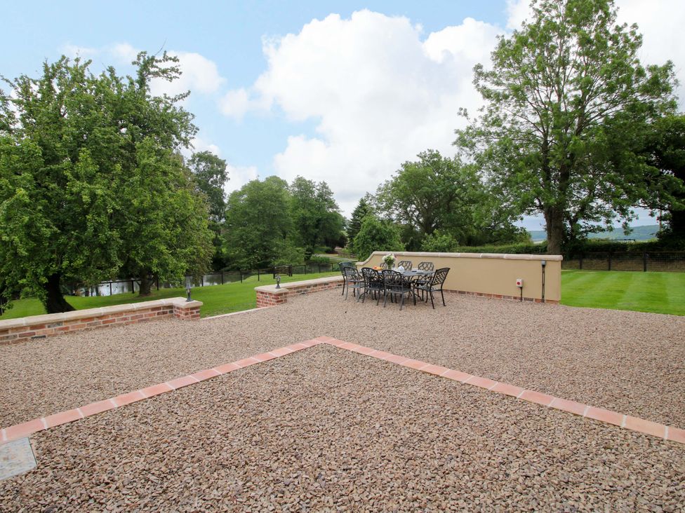 An outdoor area with a table and chairs at Highfields Farm in Church Preen near Much Wenlock
