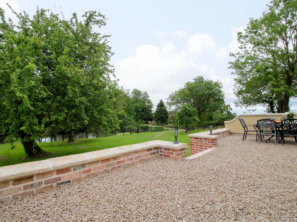 A garden area with trees and a seating arrangement at Highfields Farm Church Preen near Much Wenlock