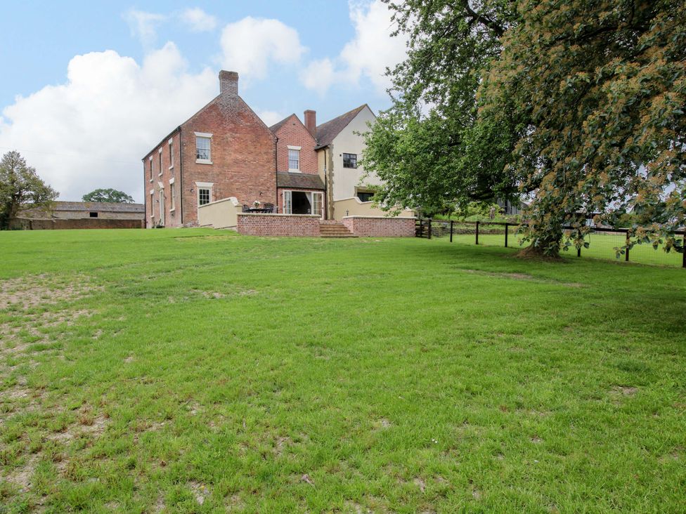 A house with green lawn and trees at Highfields Farm Church Preen near Much Wenlock