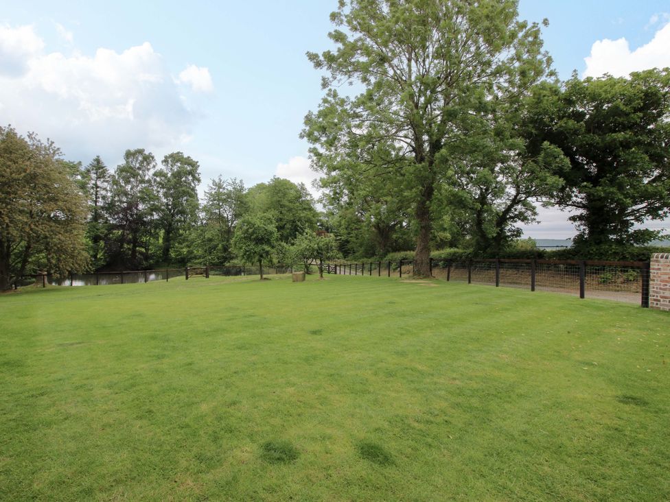 An outdoor garden with grass and trees at Highfields Farm Church Preen near Much Wenlock