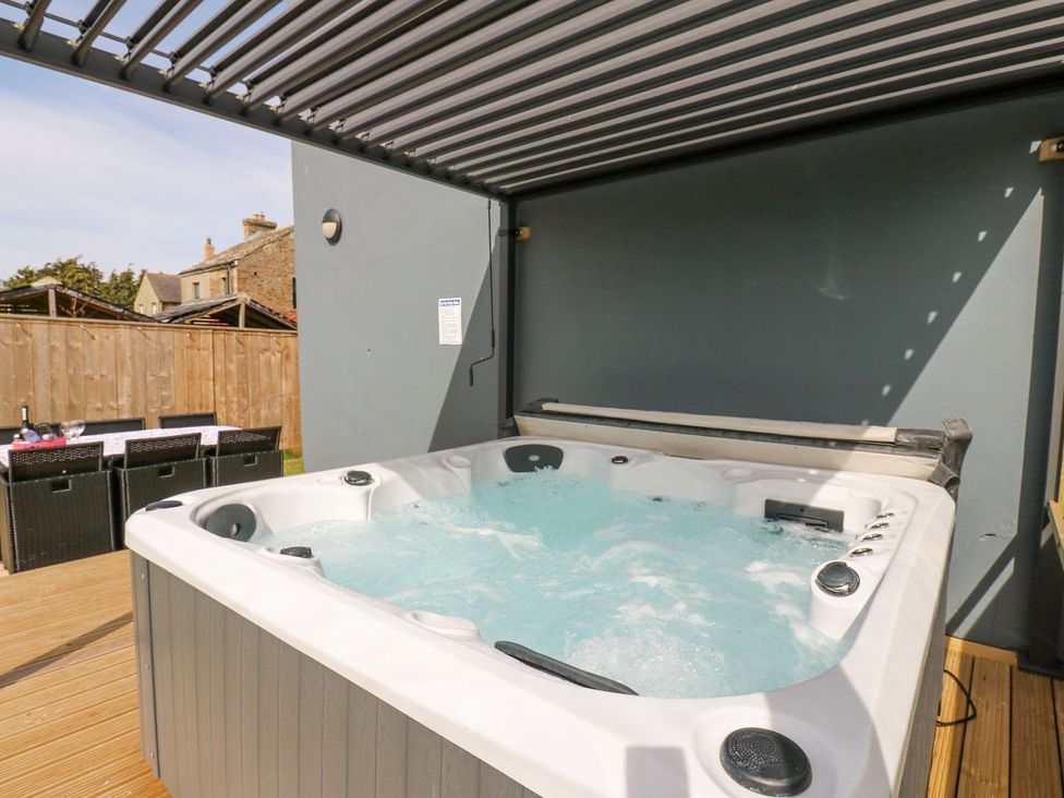 A hot tub on outdoor decking at Aurelian House St John's Chapel
