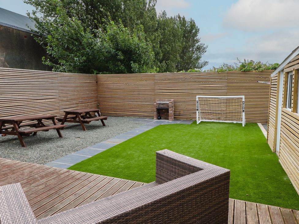 A garden with picnic tables and a goal post at 51 Trinity Avenue Llandudno