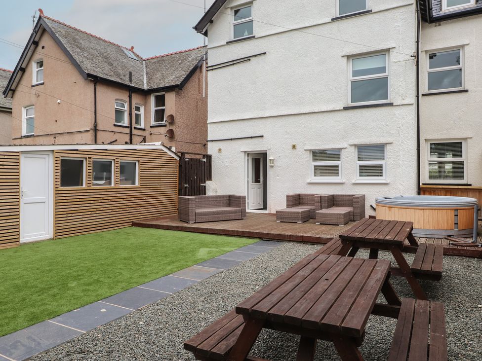 A garden with outdoor furniture and a hot tub at 51 Trinity Avenue Llandudno